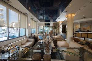 a living room with a couch and a table at Premier Agrinio Heart Hotel in Agrinio