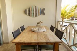 a wooden table with chairs and a bowl on top at Tortuga in Kralendijk