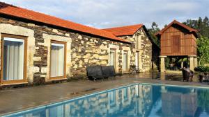 a house with a swimming pool next to a building at Casa Valxisto in Penafiel