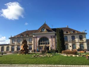 a large building with a fountain in front of it at Studios Lora RM 860 in Saint-Louis