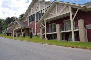 a red building with balconies on the side of a street at Vacation Lodge in Pigeon Forge