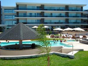 uma piscina com um grande edifício ao fundo em Altos del Arapey All Inclusive, Golf & Spa em Termas del Arapey
