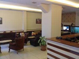 a lobby with a waiting room with couches and a tv at Isık Hotel in Edirne