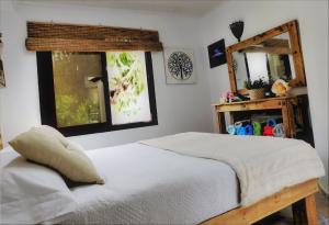 a bedroom with a white bed and a mirror at Bungalow Marbella (San Pedro Alcantara) in Marbella +13 photos