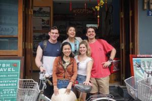 a group of people standing in front of a store at Vietnam Backpacker Hostels - Hue in Hue