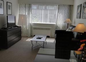 a living room with a couch and a coffee table at Rosellen Suites at Stanley Park in Vancouver