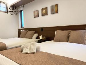 Postel nebo postele na pokoji v ubytování HOTEL CLA-SS HIROSHIMA-OZU