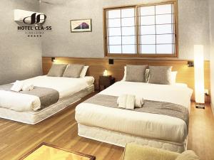 Postel nebo postele na pokoji v ubytování HOTEL CLA-SS HIROSHIMA-OZU