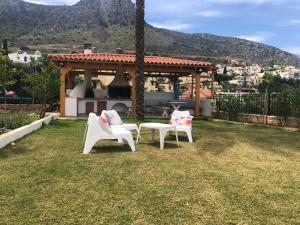 two chairs and a gazebo in a yard at Sunshine Koutouloufari in Hersonissos