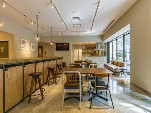 a bar in a restaurant with tables and chairs at Bay Hotel Tokyo Hamamatsucho in Tokyo