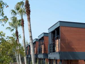 a building with palm trees in front of it at THE Retreat in Iizuka