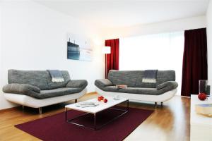 a living room with two couches and a coffee table at CITY STAY - Forchstrasse in Zurich
