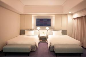 Postel nebo postele na pokoji v ubytování Hotel New Otani Makuhari