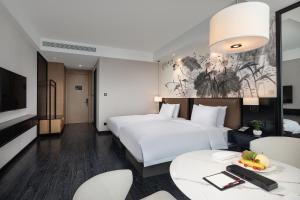Postel nebo postele na pokoji v ubytování Fuzhou Mawei Yiho Hotel