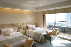 Postel nebo postele na pokoji v ubytování Hotel New Otani Makuhari
