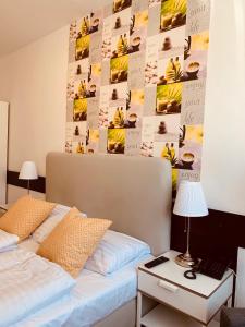 Un dormitorio con una cama y una pared con fotos de plátanos en Hotel Gloria Budapest City Center en Budapest