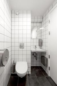 a bathroom with a toilet and a sink at BOOK1 by Brøchner Hotels in Aarhus