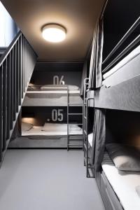 a room with two bunk beds and a staircase at BOOK1 by Brøchner Hotels in Aarhus