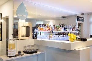 a bar with a counter with drinks on it at Hotel Santoni Freelosophy *** in Nago-Torbole