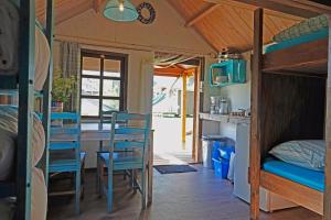 a room with a bed and a table and chairs at B&B Welgelegen in Workum
