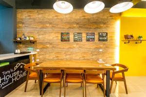 a dining room with a wooden table and chairs at Tony's house in Jiaoxi