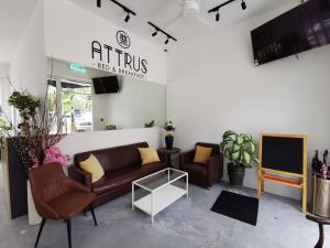 a living room with couches and a tv at LSE @ Attrus Bed & Breakfast in Johor Bahru