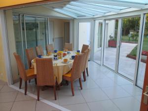 a dining room with a table and chairs at Locatlantique in Aytré