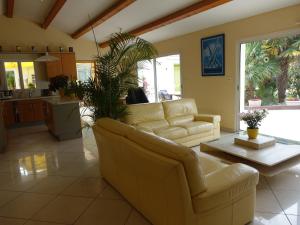 a living room with a couch and a table at Locatlantique in Aytré