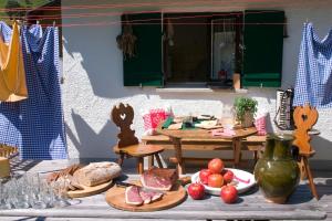 a table with plates of food on top at Almhütte & Skihütte Kohlerhaus in Stuben am Arlberg