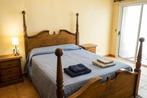 a bedroom with a bed with two towels on it at Loft Rustico in Corralejo