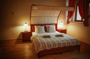 a bedroom with a bed and a dresser at Hotel Stein Elbogen in Loket