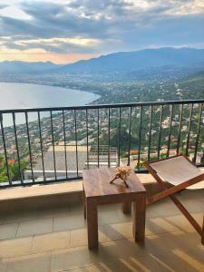 a table and a chair on a balcony with a view at Gaia (Γαία) guest house in Kalamata