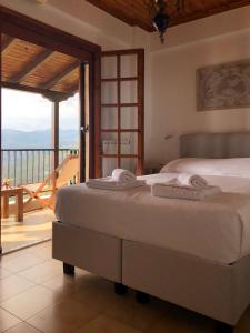 a bedroom with a bed and a balcony at Gaia (Γαία) guest house in Kalamata