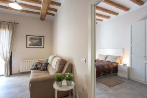 a living room with a couch and a bed at Can Salvans in Ripoll