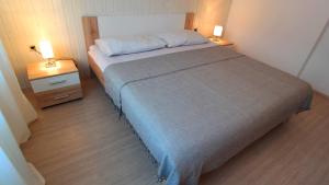 a bedroom with a bed with two night stands and two lamps at Morena in Pula