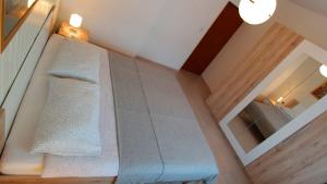 a room with a staircase with a couch and a mirror at Morena in Pula