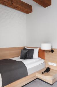 a bedroom with a bed and a lamp on a table at Copenhagen Admiral Hotel in Copenhagen