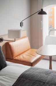 a brown chair and a table in a room at Copenhagen Admiral Hotel in Copenhagen