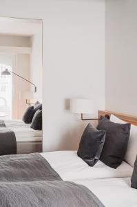 a bedroom with two beds and a mirror at Copenhagen Admiral Hotel in Copenhagen