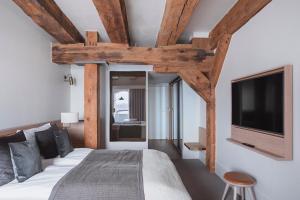 a bedroom with a large bed and a tv at Copenhagen Admiral Hotel in Copenhagen