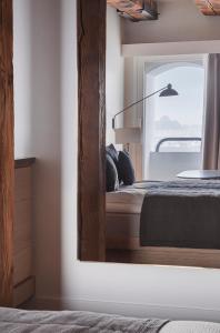 a mirror in a room with a bed and a window at Copenhagen Admiral Hotel in Copenhagen