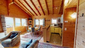 a kitchen and living room in a log cabin at Danica in Blatten bei Naters +29 photos