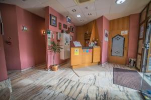 an empty room with pink walls and a potted plant at Hotel las Cruces in Belmonte de Miranda