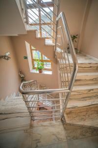 a staircase in a house with a metal railing at Hotel las Cruces in Belmonte de Miranda