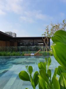a swimming pool with a building in the background at Minh Boutique in Danang