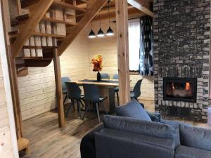 a living room with a couch and a fireplace at Skrzynia 12 in Skrzynia
