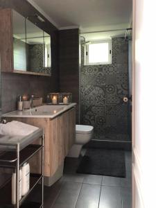 a bathroom with a sink and a toilet and a shower at Gaia (Γαία) guest house in Kalamata