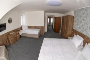 Voodi või voodid majutusasutuse Hotel Prichovice toas