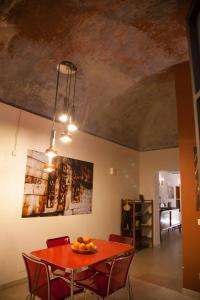 a dining room with a red table and chairs at Naturalmente abitare in Catania