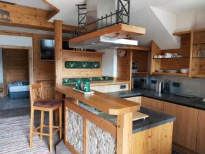 a kitchen with wooden cabinets and a counter top at Neueröffnung Buchbergdomizil in Bischofshofen